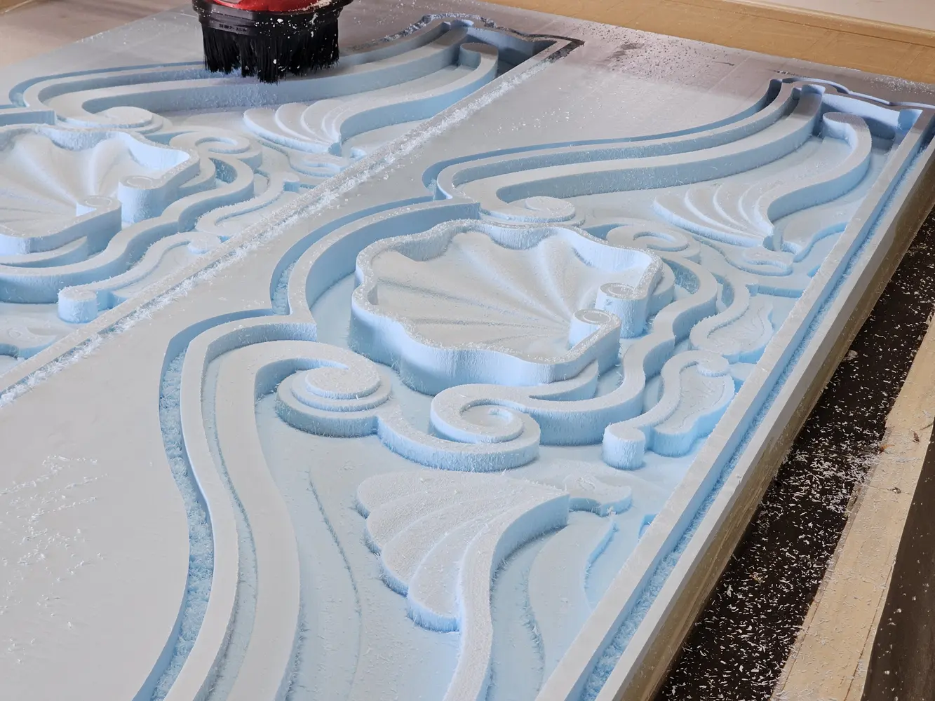 Ornamental architectural pediment being machined from foam