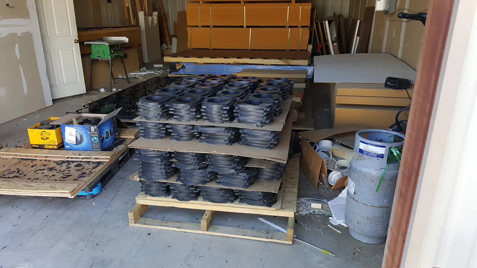 Repeat CNC-machined parts staged for commercial speaker enclosure production